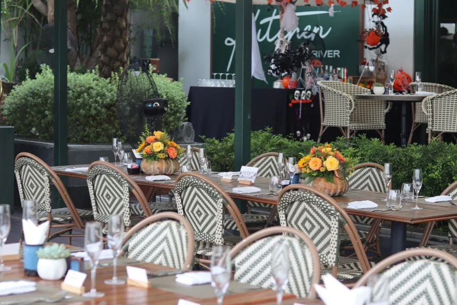 Halloween-decorated riverside terrace tables at Kitchen by the River, Mia Saigon